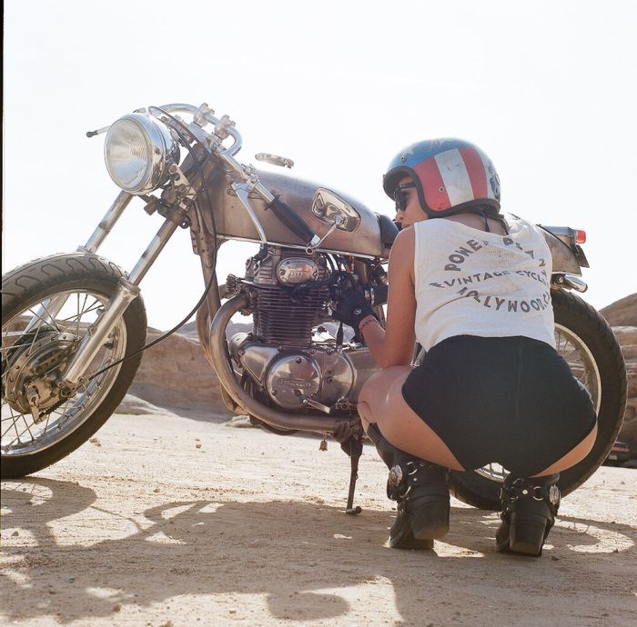 A playful frame from Girls on a motorcycle — online in Yichun